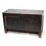 A distressed 18th century stained pine coffer with (later) plank top over a joint frame, the twin
