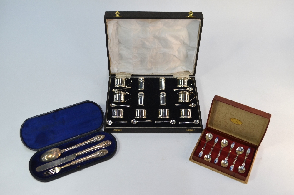 A cased twenty piece silver condiment set with blue glass liners including spoons, Birmingham 1938