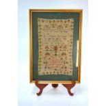 A George IV cross-stitch needlework sampler worked with floral designs and improving spiritual text,