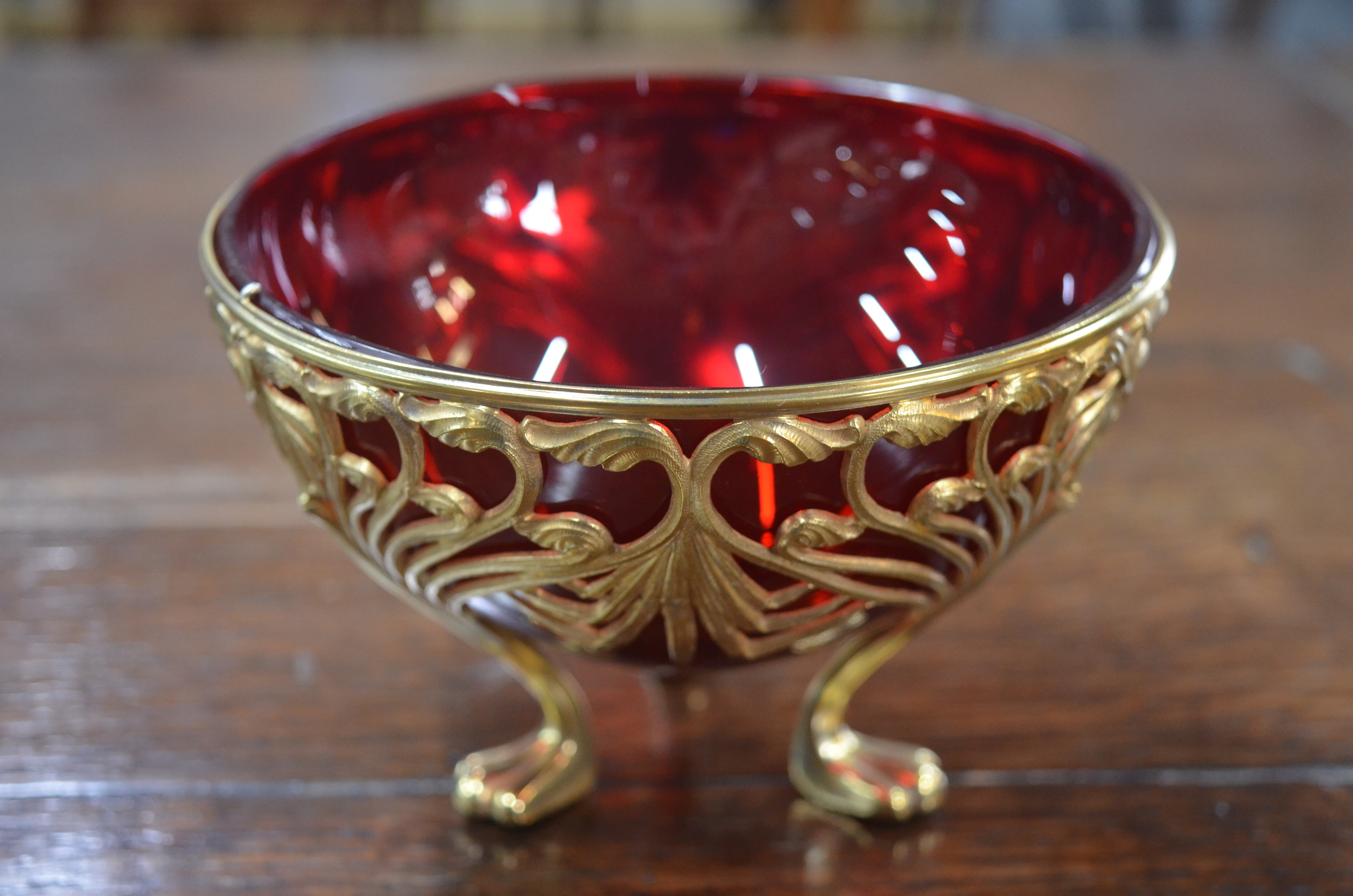 A late 19th century Continental gilt metal Art Nouveau sugar basin with ruby glass liner, with