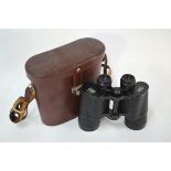 A leather-cased pair of Carl Zeiss Jenoptem 10 x 5 0w binoculars Light wear to lacquer, slight