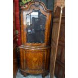 A Dutch bowfront floral marquetry walnut standing corner cabinet in two parts, the upper with arched