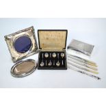 An engine-turned cigarette box, Birmingham 1960, to/w a cased set of six seal-top coffee spoons,