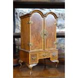 A miniature William & Mary style crossbanded walnut double dome top cabinet, the arched doors