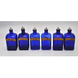 A set of six Bristol blue glass square chamfered drug/poison bottles with metal topped cork stoppers