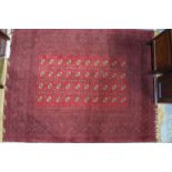 An Afghan Turkoman design rug, the four rows of guls on mid red ground, 220 x 159 cm