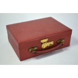 A rectangular red leather jewel box having removable tray and three removable cushions, lever