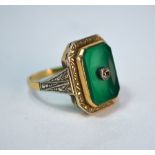 A green dyed agate and diamond Art Deco style ring, with engraved shoulders, yellow and white
