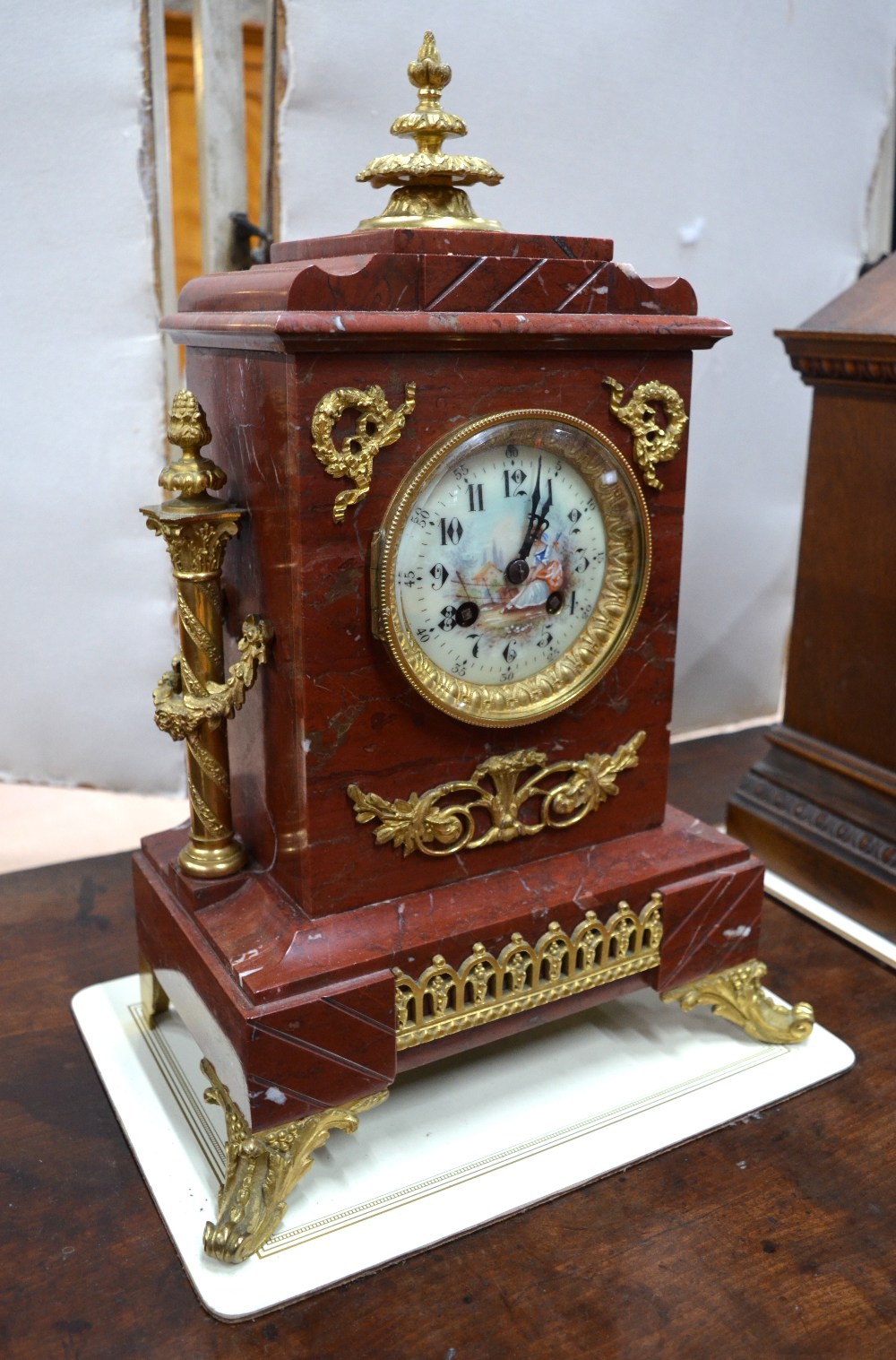A late 19th century gilt bronze mounted rouge veined marble eight-day mantel clock, the two train