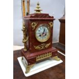 A late 19th century gilt bronze mounted rouge veined marble eight-day mantel clock, the two train