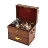 A 19th century mahogany apothecary box containing numerous bottles, balance scale weights and a