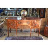 A 19th century Sheraton style inlaid and cross-banded satinwood bowfront sideboard, the top with