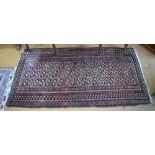 An old Beloch long rug, the red-brown ground with three rows of rectangular guls, 184 x 95 cm