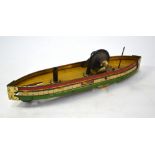 A tinplate paddle-boat with flywheel drive, 30 cm long