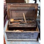 A vintage stained pine carpenter's tool trunk with assorted contents including block and moulding