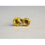 A pair of yellow sapphire claw set ear studs for pierced ears
