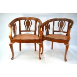 A pair of vintage teak framed chairs with rattan seat panels (2)