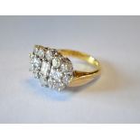 A diamond set cluster ring having three baguette diamonds in centre, with twelve brilliant cut