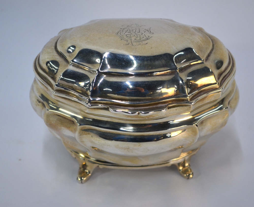 A late Victorian silver tea caddy in the Georgian manner, of bombe form, on scroll feet,