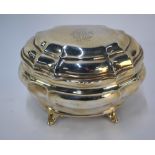 A late Victorian silver tea caddy in the Georgian manner, of bombe form, on scroll feet,
