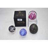 Four Caithness glass paperweights comprising  'Cauldron Ruby' c/w box, an ovoid paperweight, 8 cm