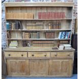 A large 19th century country house stripped pine dresser, the open tier planked back over three