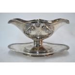 A French 950 grade double-lipped sauce boat with loose liner, foliate and scroll cast and chased