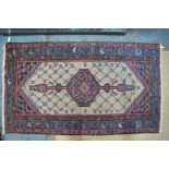 An old Persian Kurd rug, the lattice design centred by a lozenge medallion on camel ground, 180 x