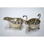 A pair of silver sauce-boats with gadrooned rims, scroll handles and hoof feet, William Hutton &