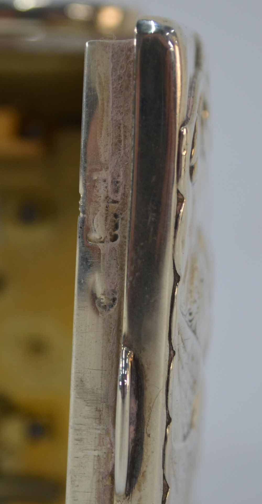 An Edwardian silver boudoir clock, embossed with winged cherub heads and scrolls, swing handle and - Image 5 of 7