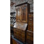 An 18th century feather banded walnut bureau cabinet, the moulded cornice over a pair of fielded