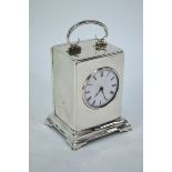An Edwardian silver boudoir clock with platform escapement and enamel dial, the case with top