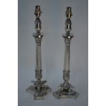 A pair of silver plated Empire style table lamps with fluted pillars on triform bases, 51 cm overall