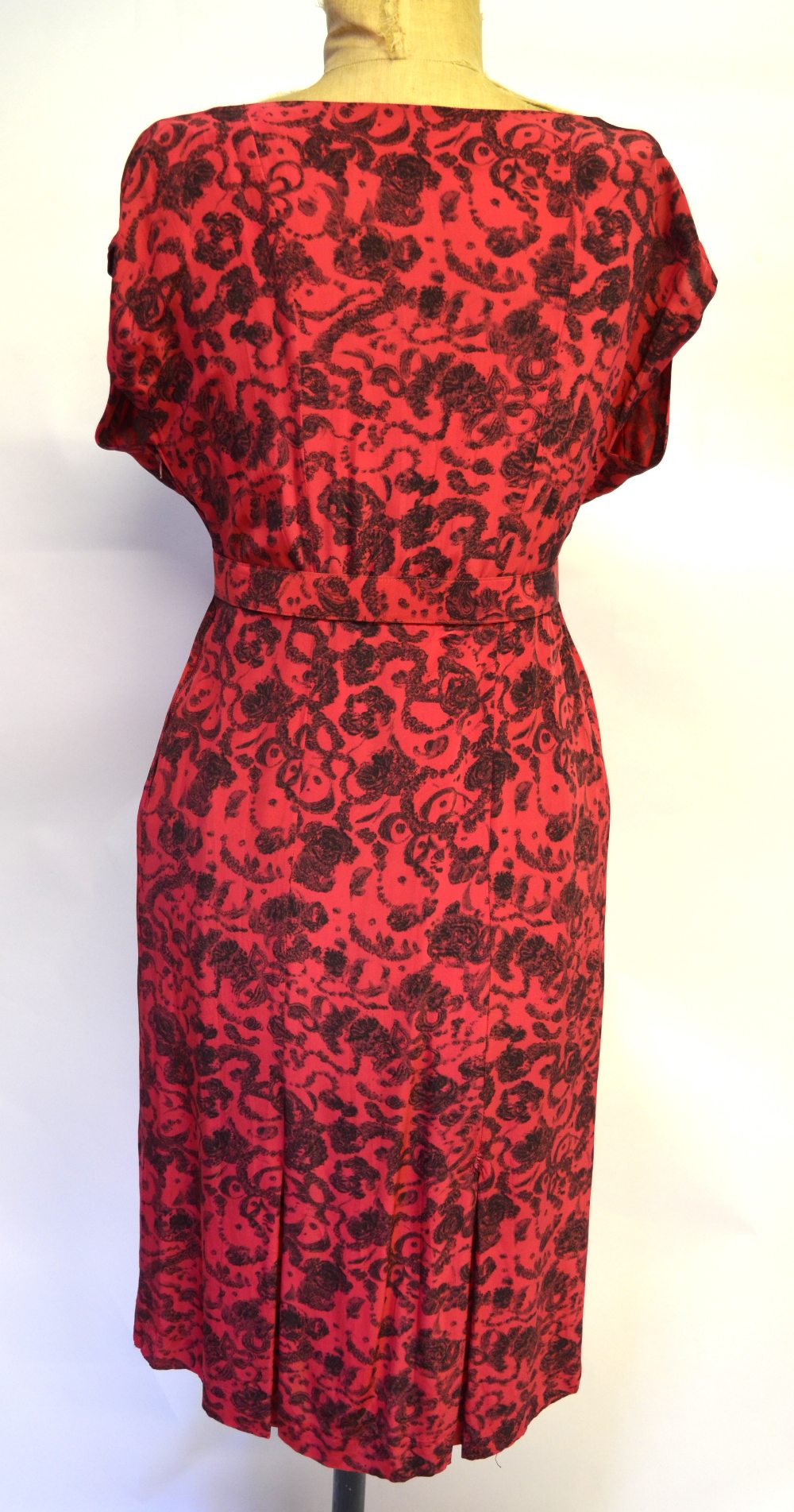 A 1940s red silk dress with black garland print, ruched waist falling to fringed drape, the belt - Image 2 of 4