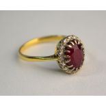 A ruby and diamond oval cluster ring, yellow and white claw setting, size P, not marked