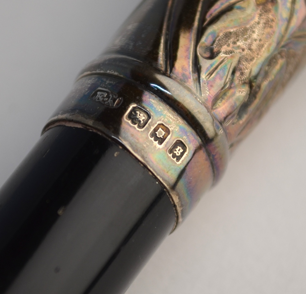 An orchestral conductor's baton, ebonised and with embossed and chased silver mounts, Ebenezer