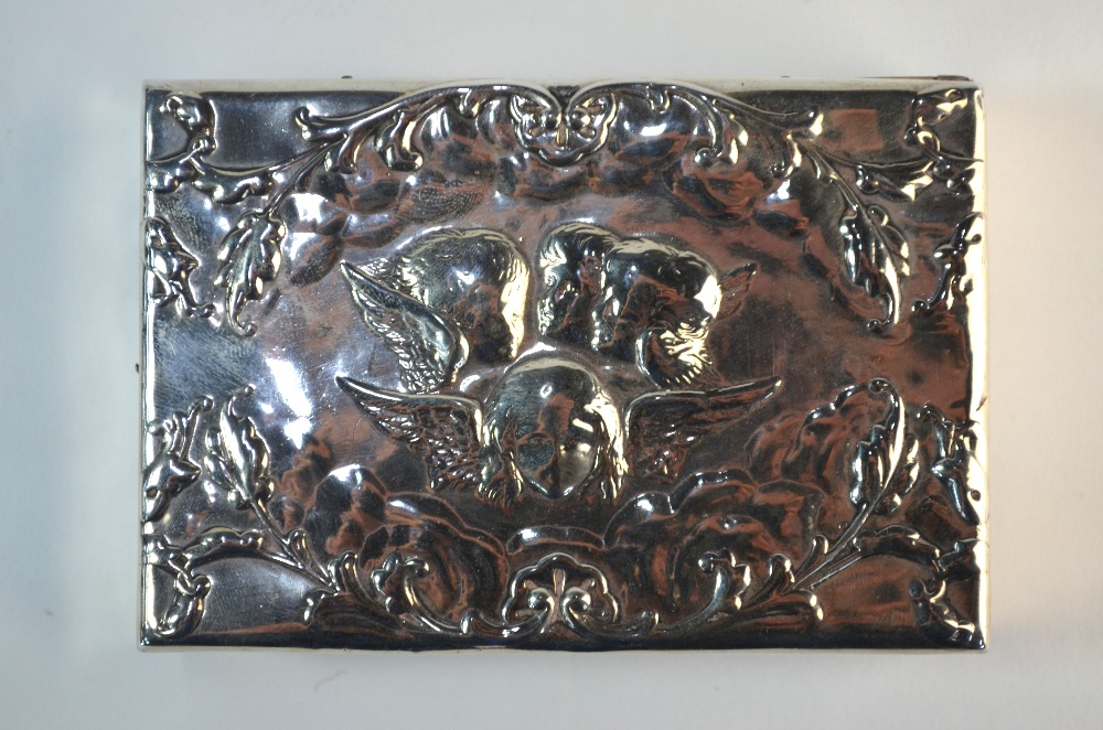 A late Victorian silver stamp-box, embossed with winged cherub heads, ebony lining with curved - Image 2 of 5