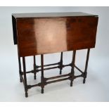 A 19th century spider table, the square edge hinged leaf top raised on slender turned gateleg frame,