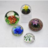 A Caithness glass paperweight incorporating a yellow lampwork spring flower with leaves and