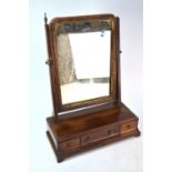 A 19th century mahogany toilet mirror, the rectangular plate raised over a three drawer fall front