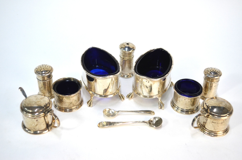 An Edwardian pair of elliptical silver open salts and seven other condiments to/w three small