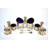 An Edwardian pair of elliptical silver open salts and seven other condiments to/w three small