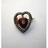 An antique red enamel heart shaped pendant set central diamond suspended within a diamond set