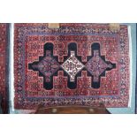 A Persian Senneh rug, the triple pole design on dark blue to red ground, 167 x 114 cm