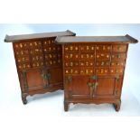 A companion pair of Asian hardwood cabinets each having sixteen drawers with two drawers over a pair