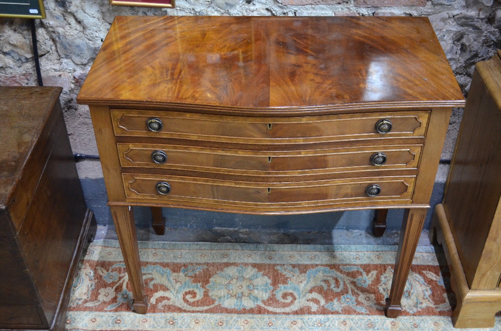 A figured mahogany canteen table with three fitted drawers, containing a part set of electroplated
