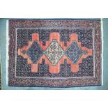 A Persian Senneh rug, the triple pole design on red/blue ground, 166 x 115 cm