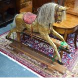 An antique pine rocking horse with horse-hair mane and tai, remnents of oiginal leather fitting