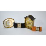 A 1930s Art Deco gilt metal strut-clock with ivory dial, to/w two purse-watches in leather-bound