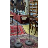 A companion pair of antique wrought floor standing candelabra in the 17th century style, raised on